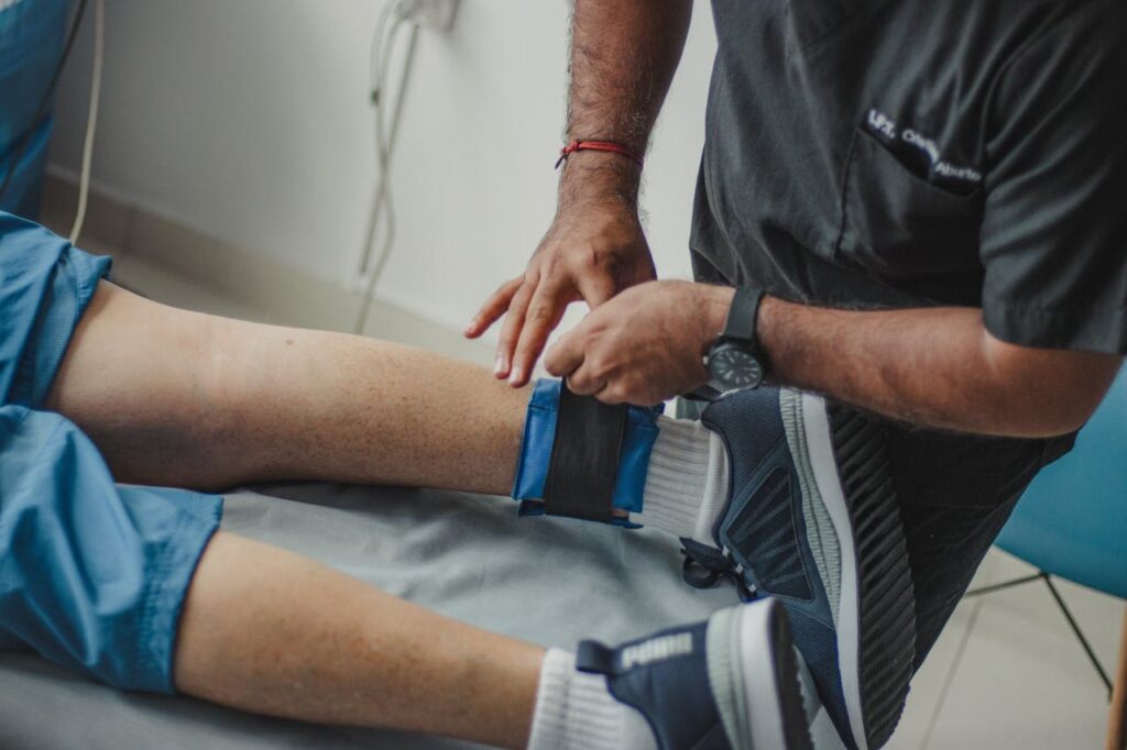 Physiotherapist adjusting leg weight